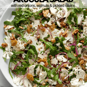 Shaved cauliflower arugula salad on a plate.