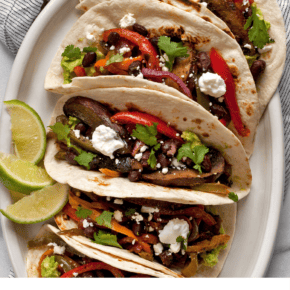 Mushroom and pepper fajitas assembled on a plate.