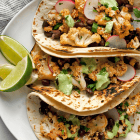 Three cauliflower tacos on a plate.