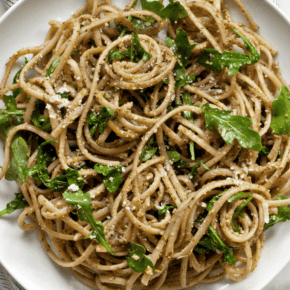 Arugula pesto pasta on a plate.