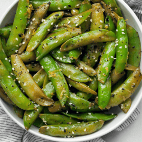 Sautéed snap peas in a bowl.