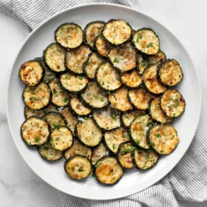Parmesan roasted zucchini on a plate.