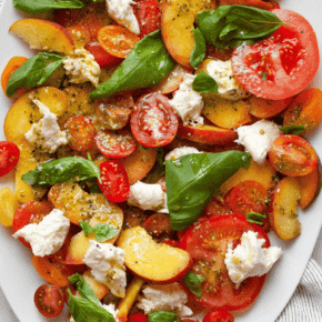 Caprese salad with peaches and tomatoes on a plate.