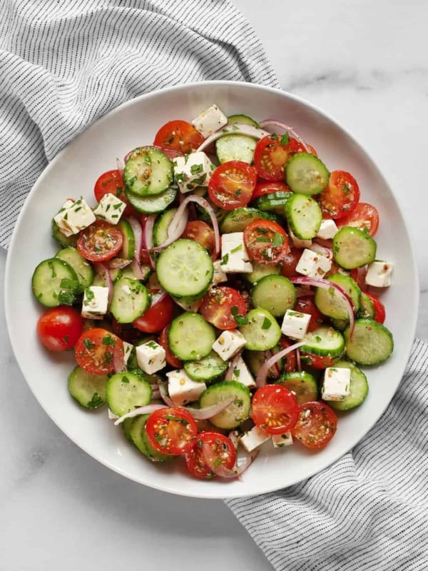 Tomato cucumber feta salad on a plate.