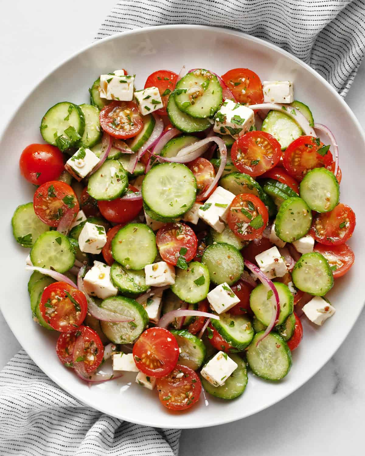 Cucumber tomato feta salad on a plate.