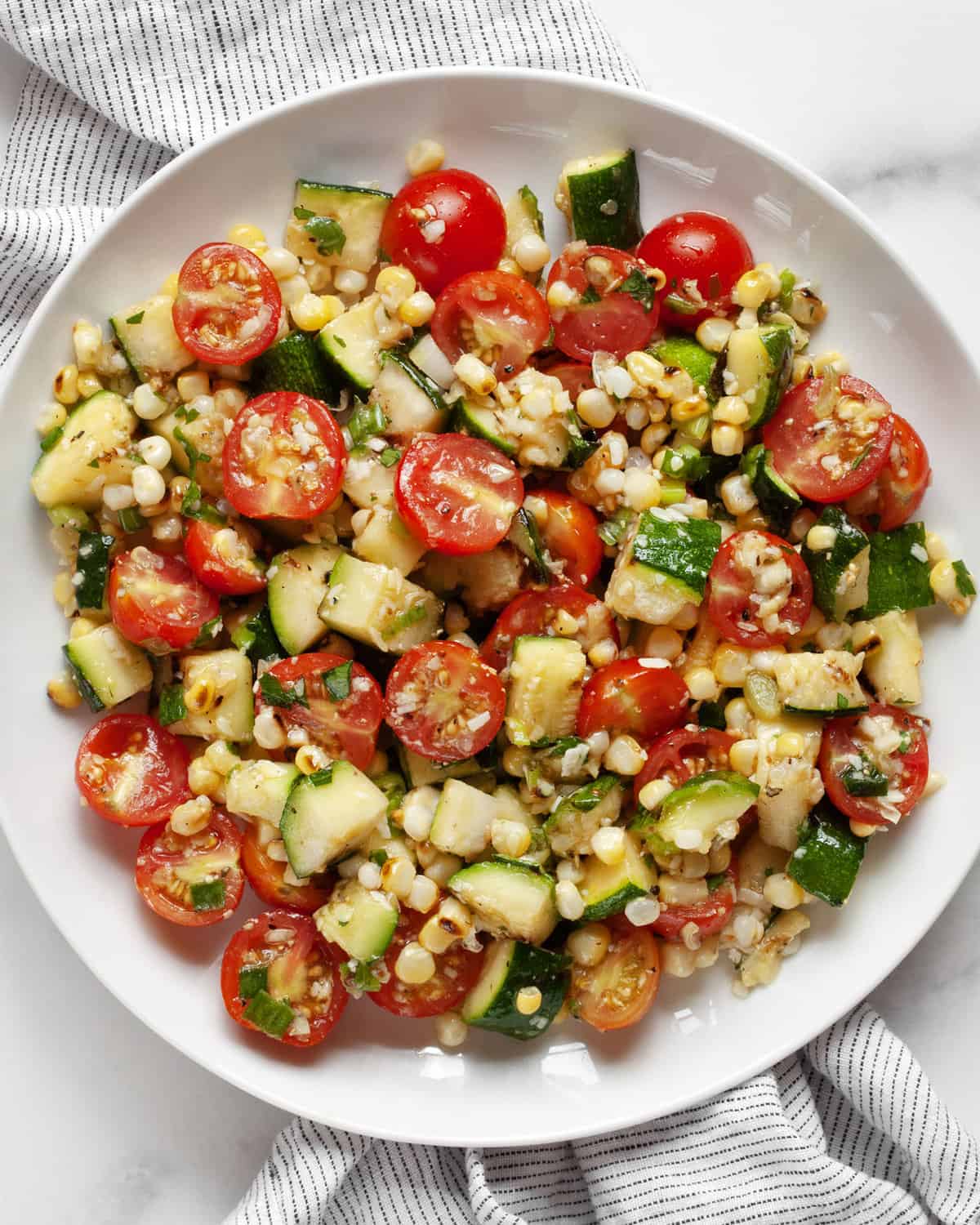 Grilled zucchini corn salad on a plate.