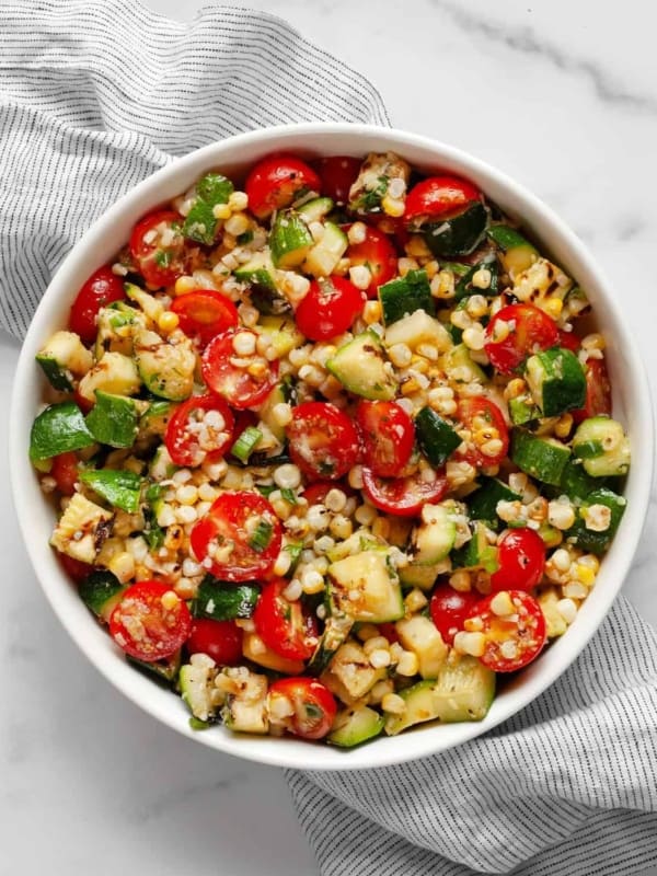 Zucchini salad with corn and tomatoes in abowl.