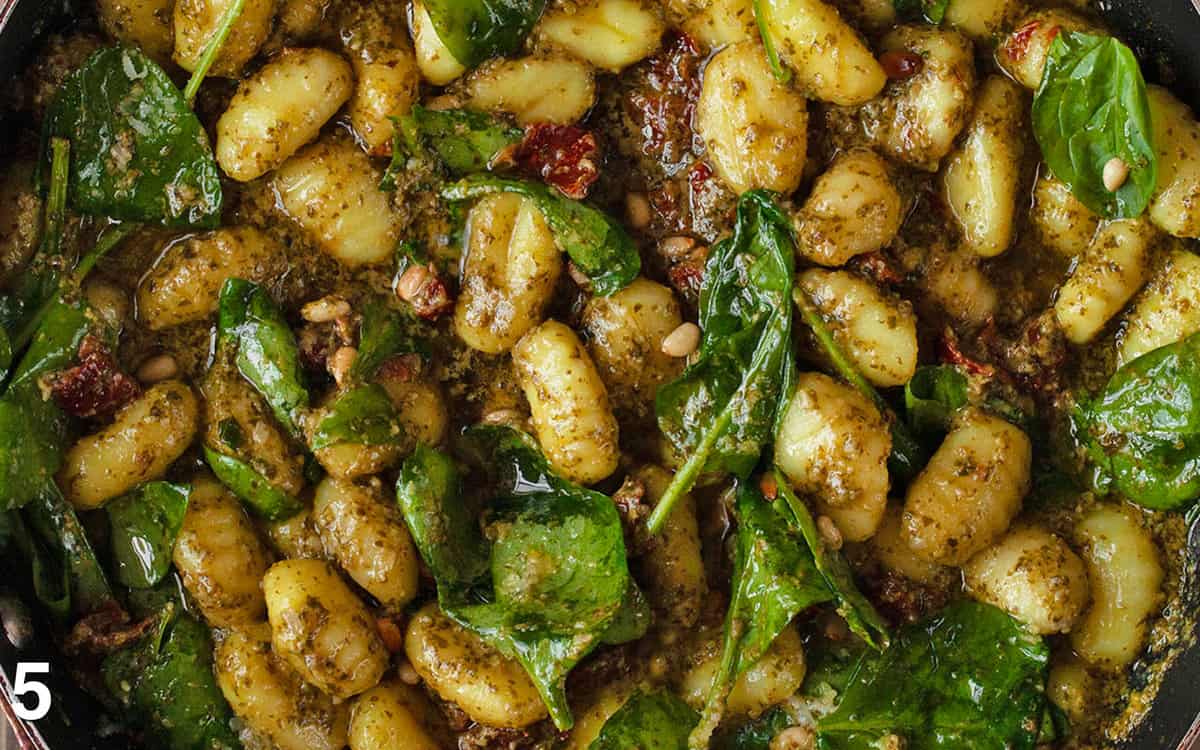 Gnocchi with sun dried tomatoes and spinach simmered in pesto and fresh lemon juice.