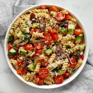 Pasta salad with Italian dressing in a bowl.