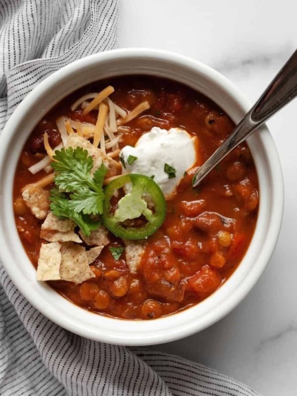 Pumpkin chili with toppings in a bowl.