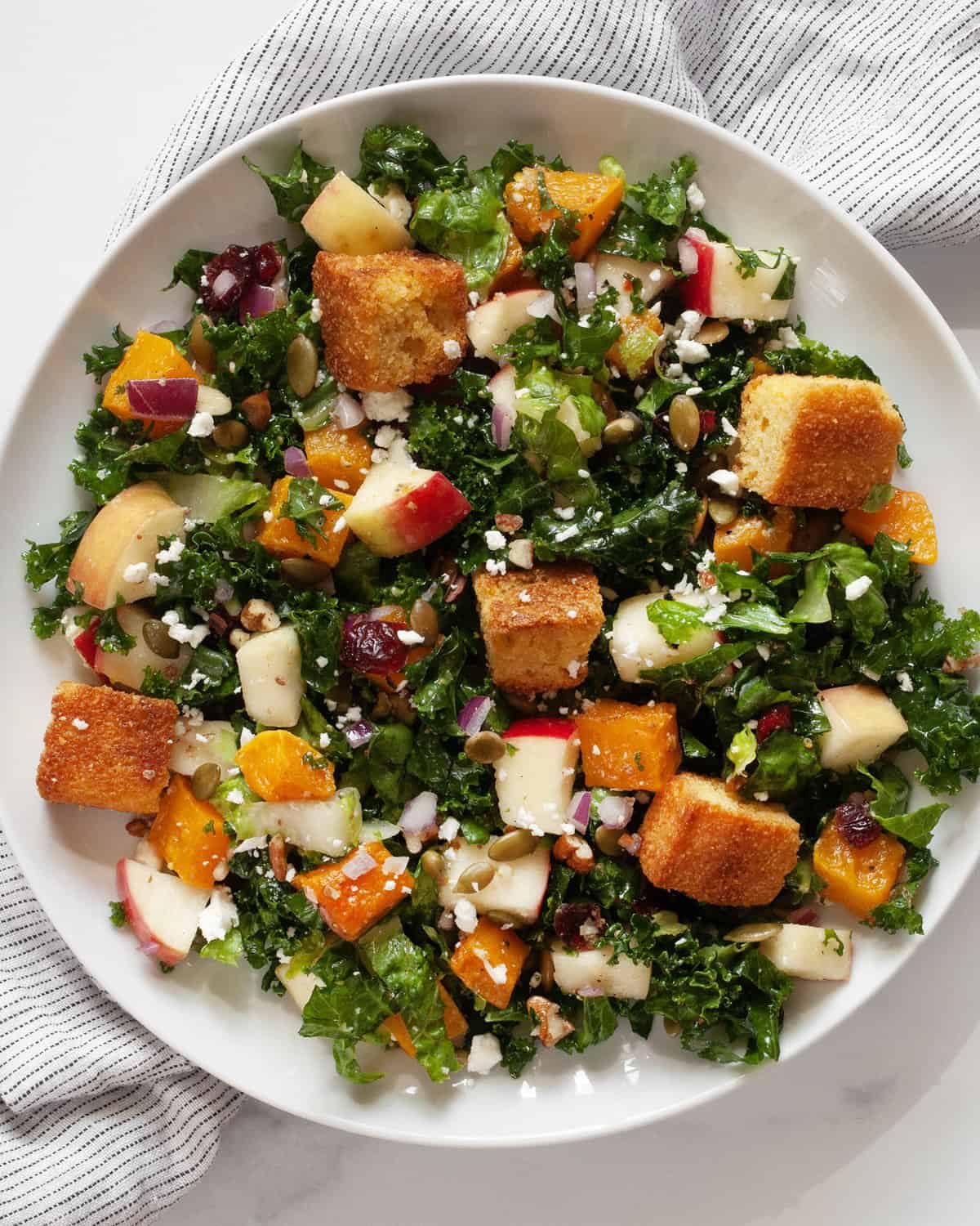 Fall harvest salad with roasted butternut and apples on a plate.