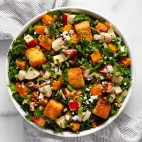 Fall salad with roasted butternut squash and apples in a bowl.