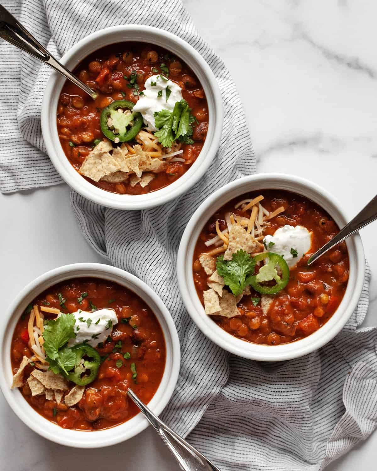 Three bowls of pumpkin chili.