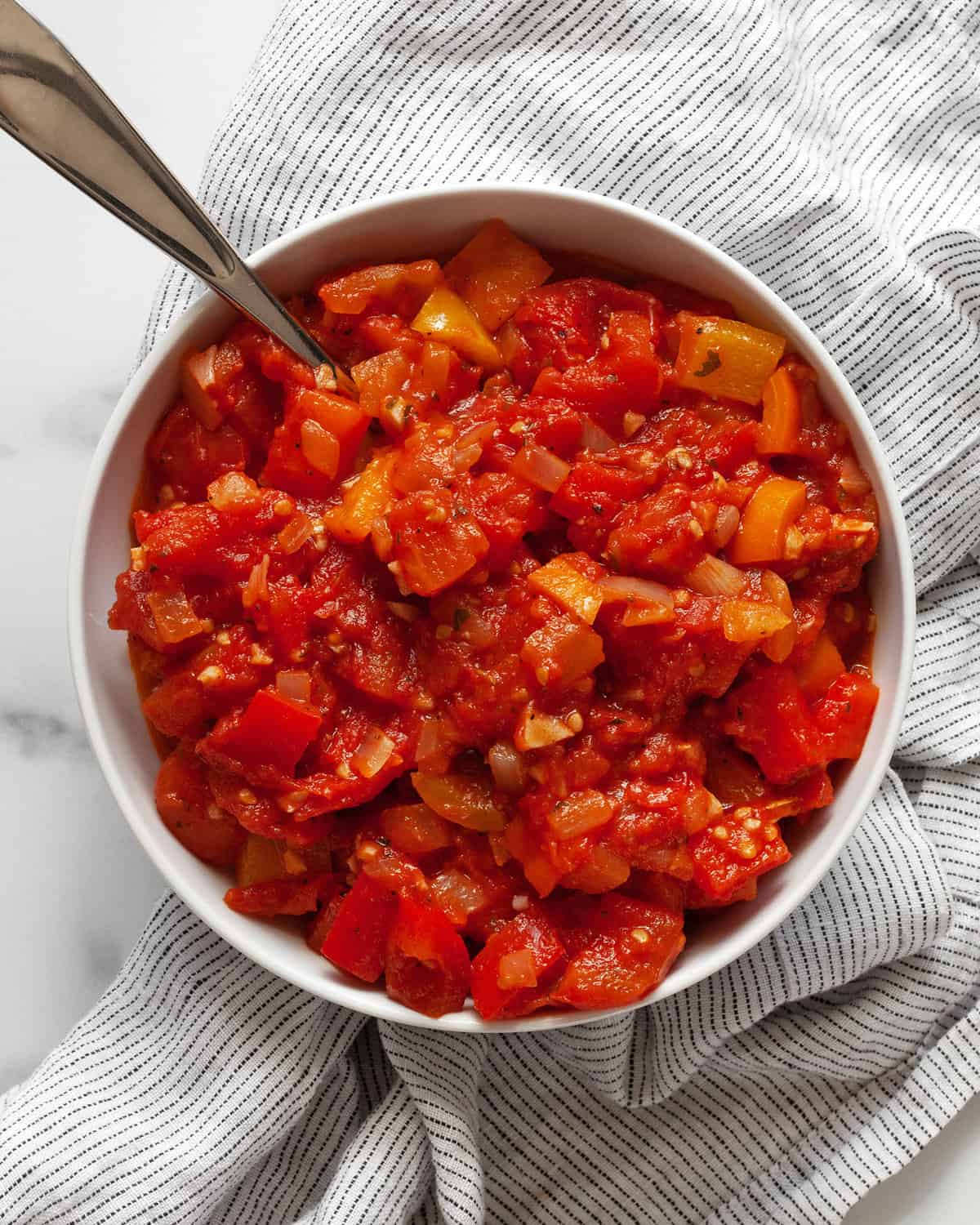 Stewed tomatoes in a small bowl.