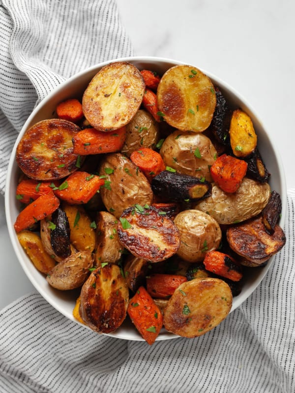 Roasted potatoes and carrots in a bowl.