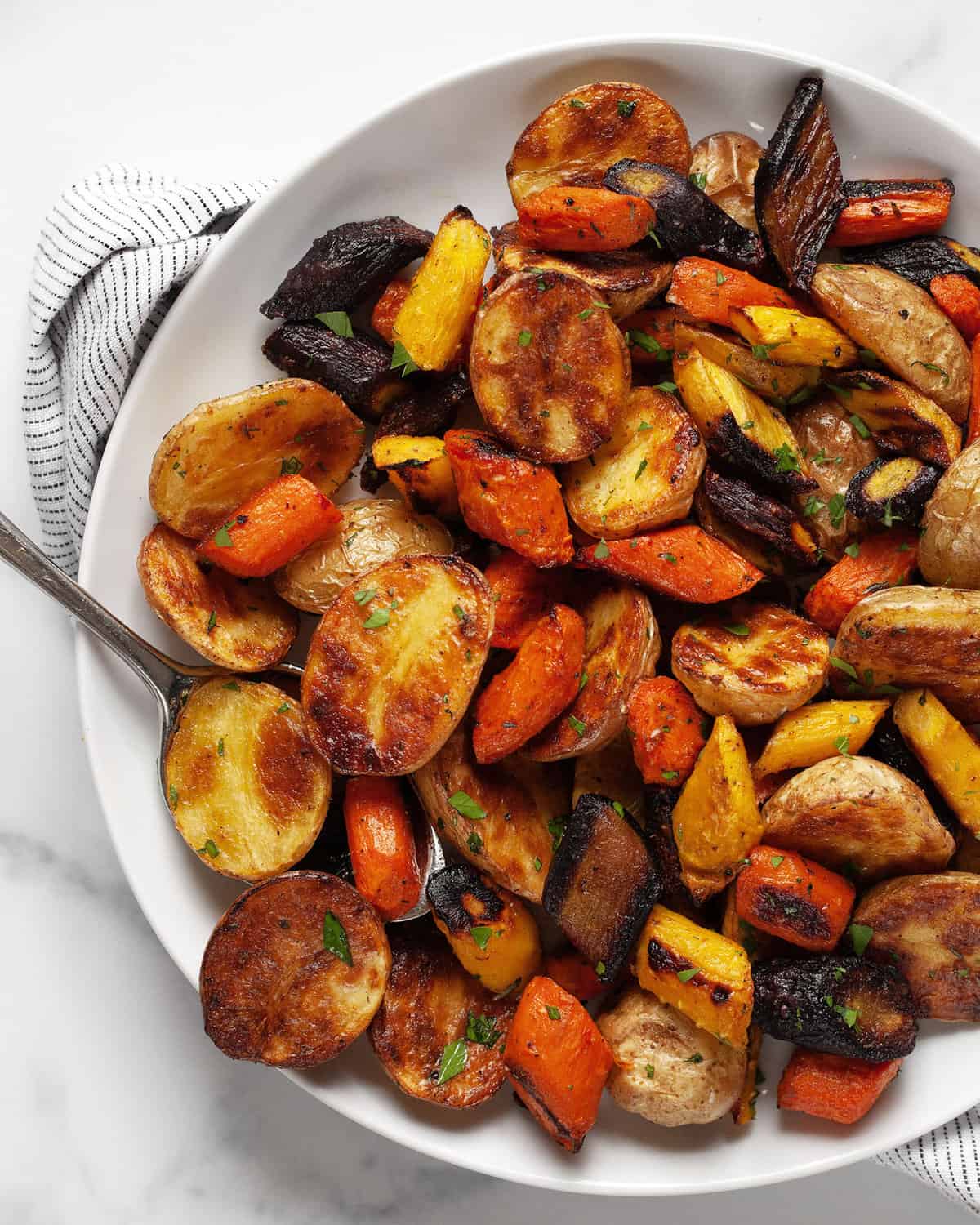 Roasted carrots and potatoes on a plate.