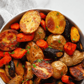 Roasted potatoes and carrots in a bowl.