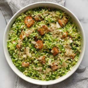 Brussels sprout salad with egg-free, anchovy-free Caesar dressing in a bowl.