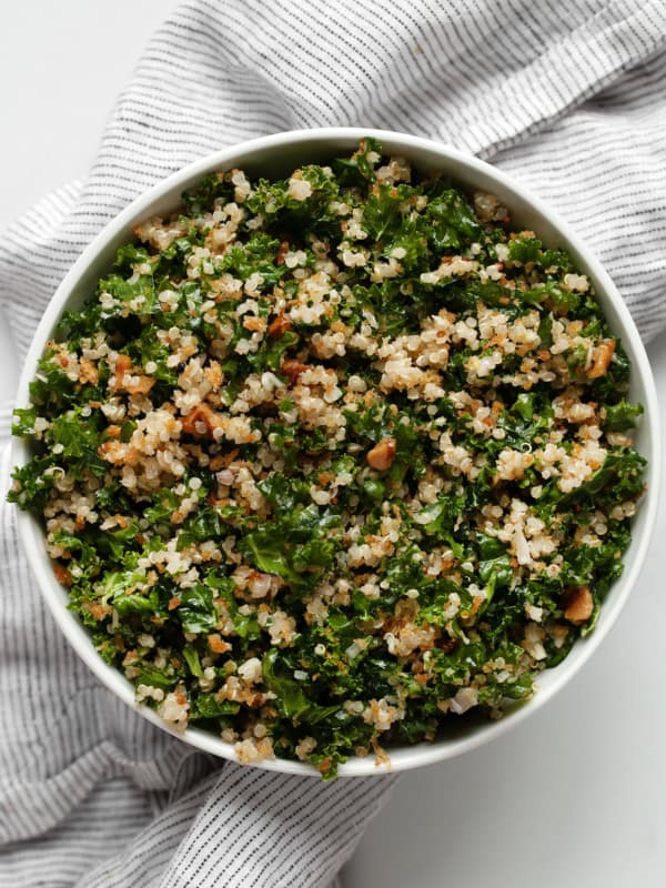 Quinoa salad with chopped kale in a bowl.
