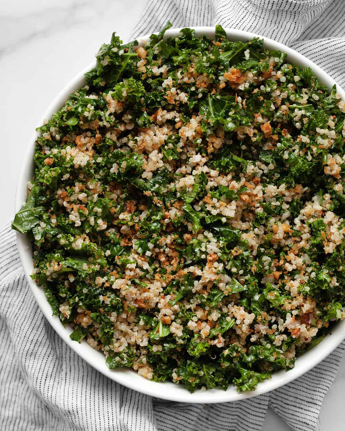 Kale salad with quinoa in a bowl.