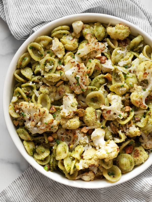 Roasted cauliflower pasta with spinach pesto in a bowl.