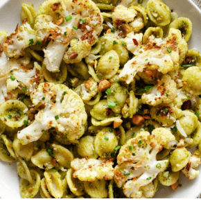 Roasted cauliflower pasta with spinach pesto on a plate.