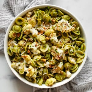 Roasted cauliflower pasta with spinach pesto in a bowl.