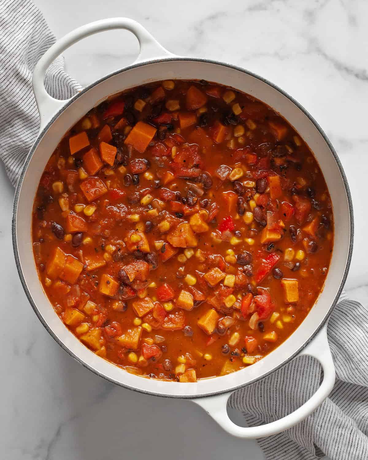 Large pot of vegetarian chili with sweet potatoes and black beans.