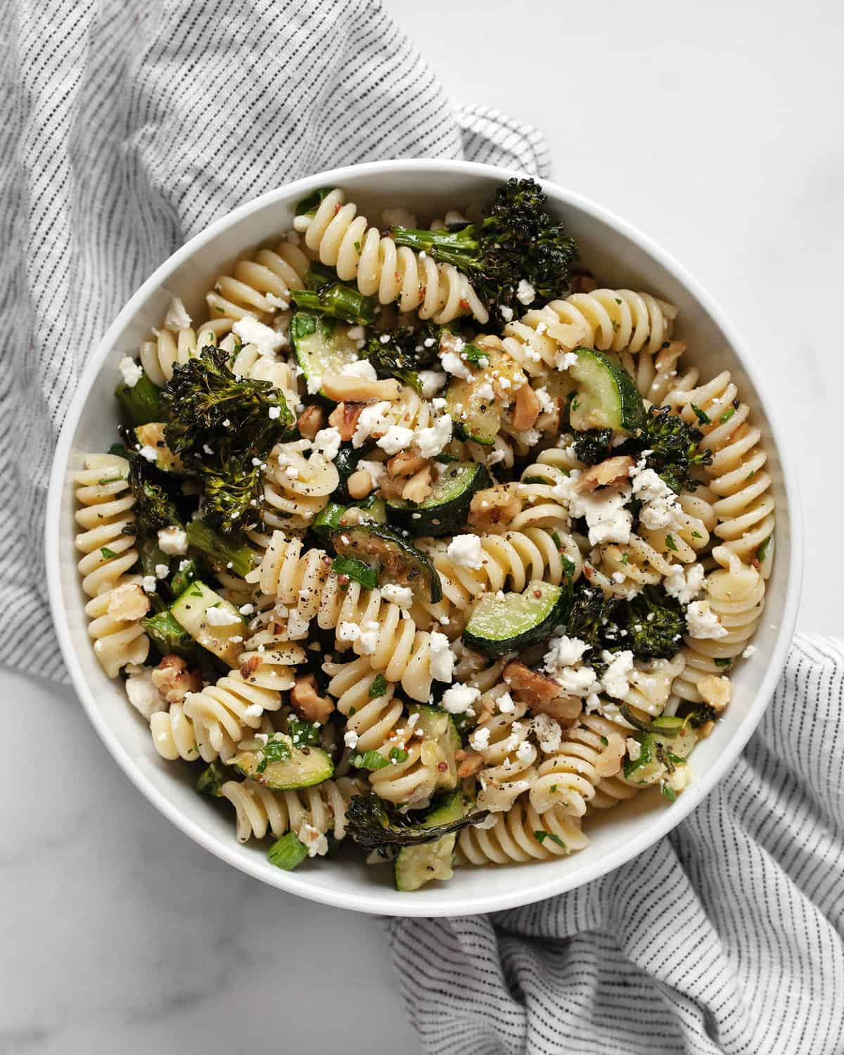 Broccolini zucchini pasta salad in a bowl.