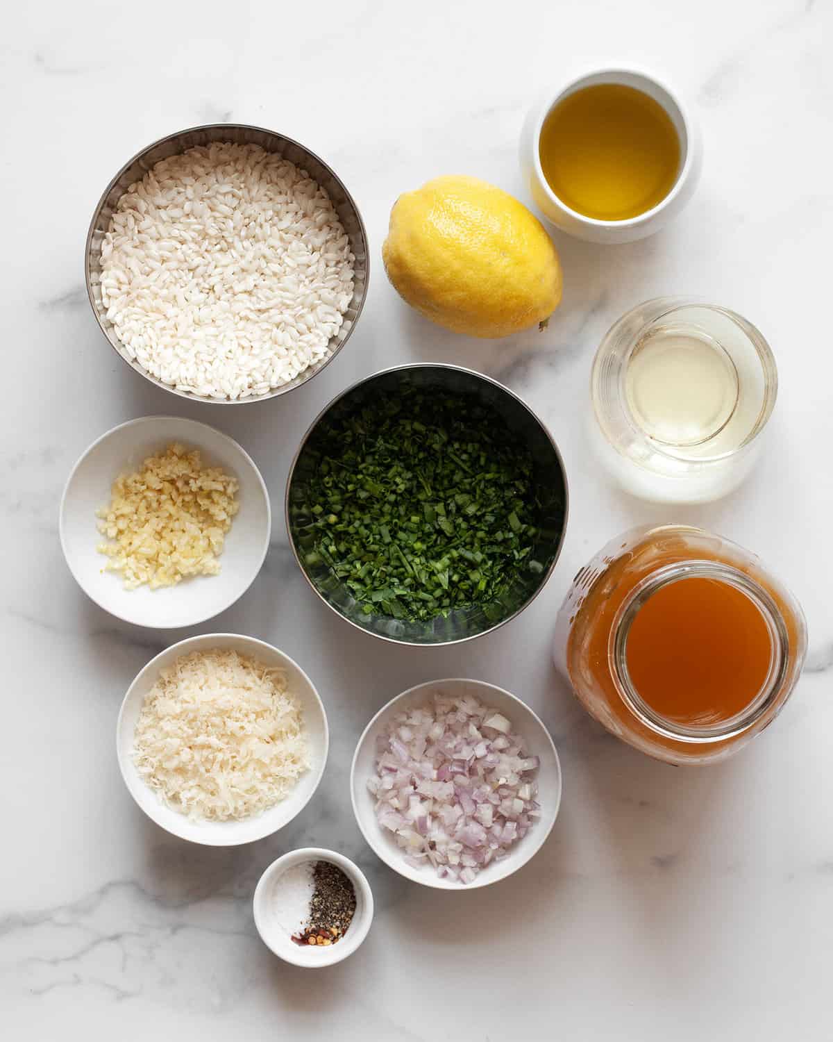 Ingredients including arborio rice, lemon, parmesan, shallots, garlic, herbs, vegetable broth, salt and pepper.