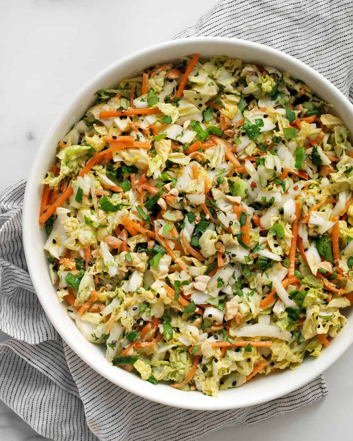 Napa cabbage salad with peanut dressing in a bowl.