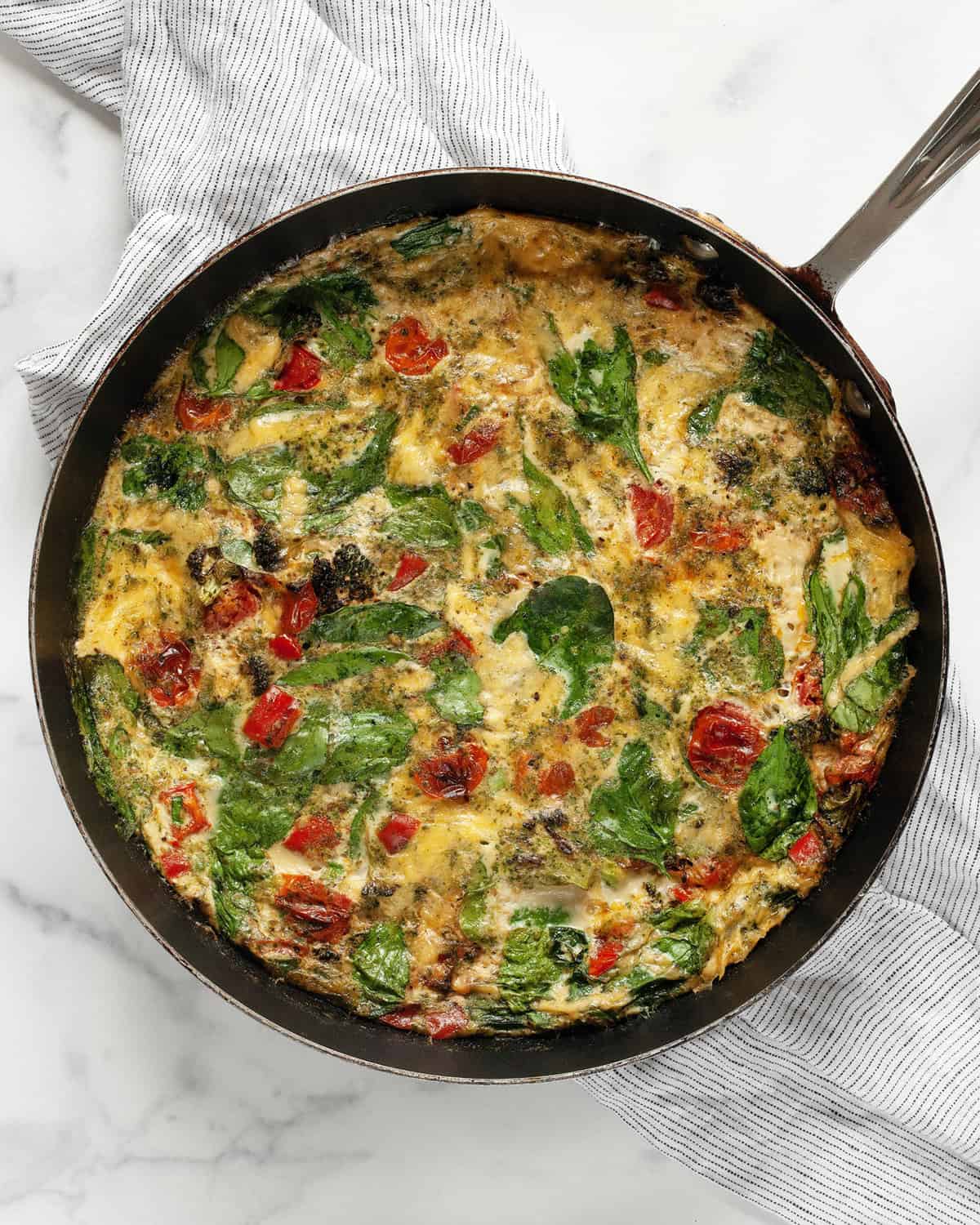 Egg white frittata with roasted vegetables in a skillet.