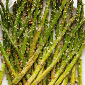 Raosted asparagus spears on a plate.