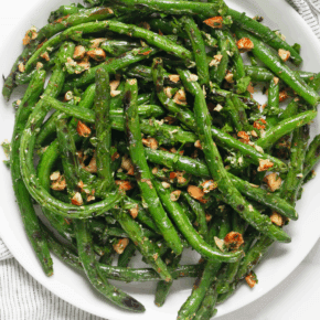 Grilled green beans on a plate.