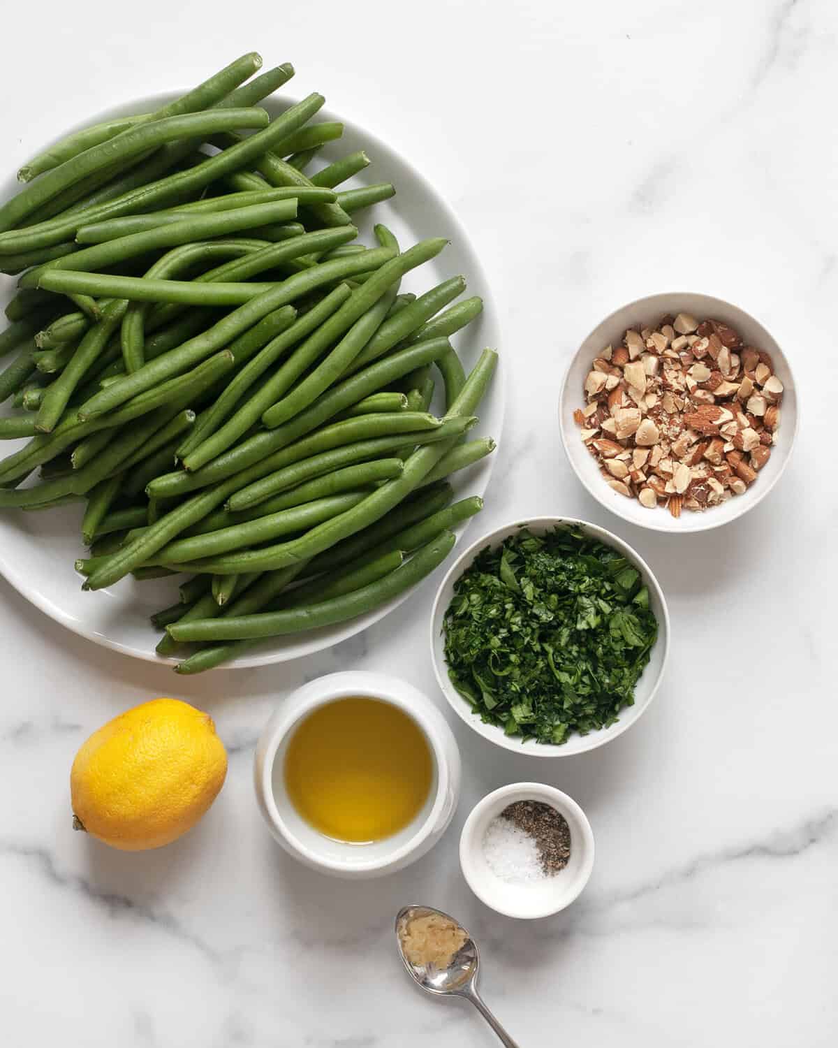 Ingredients including green beans, lemon, parsley, almonds, garlic, salt and pepper.