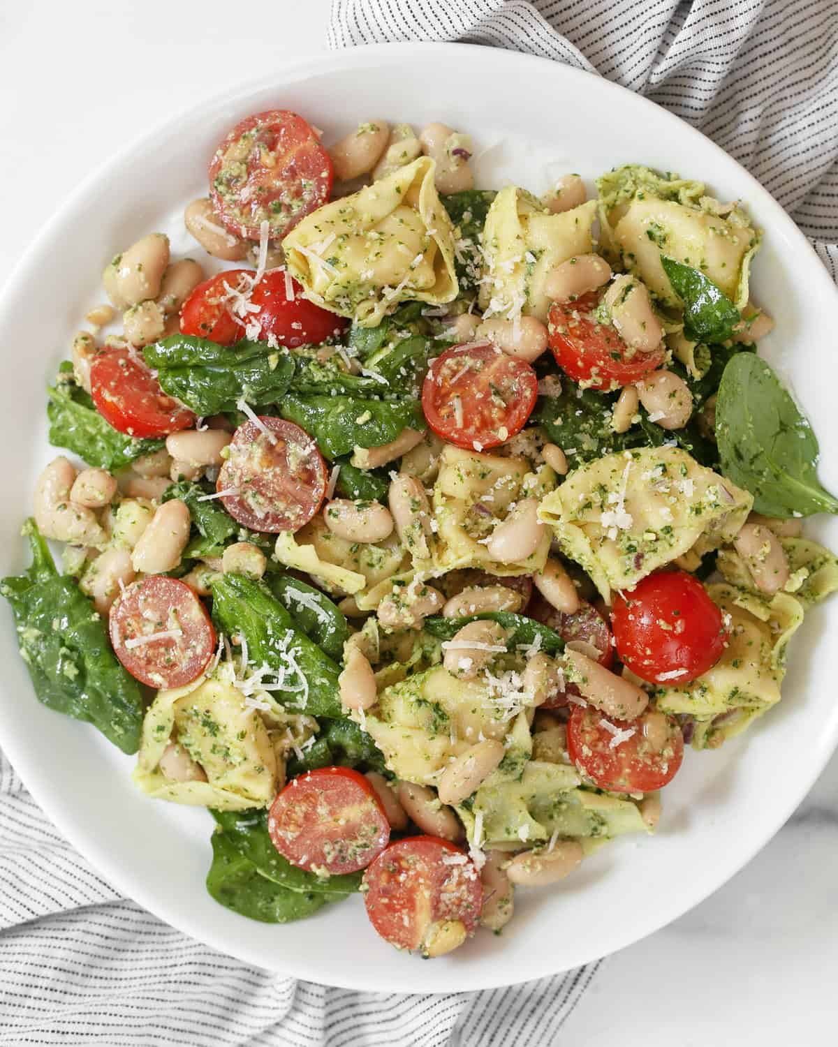 Pesto tortellini salad on a plate.