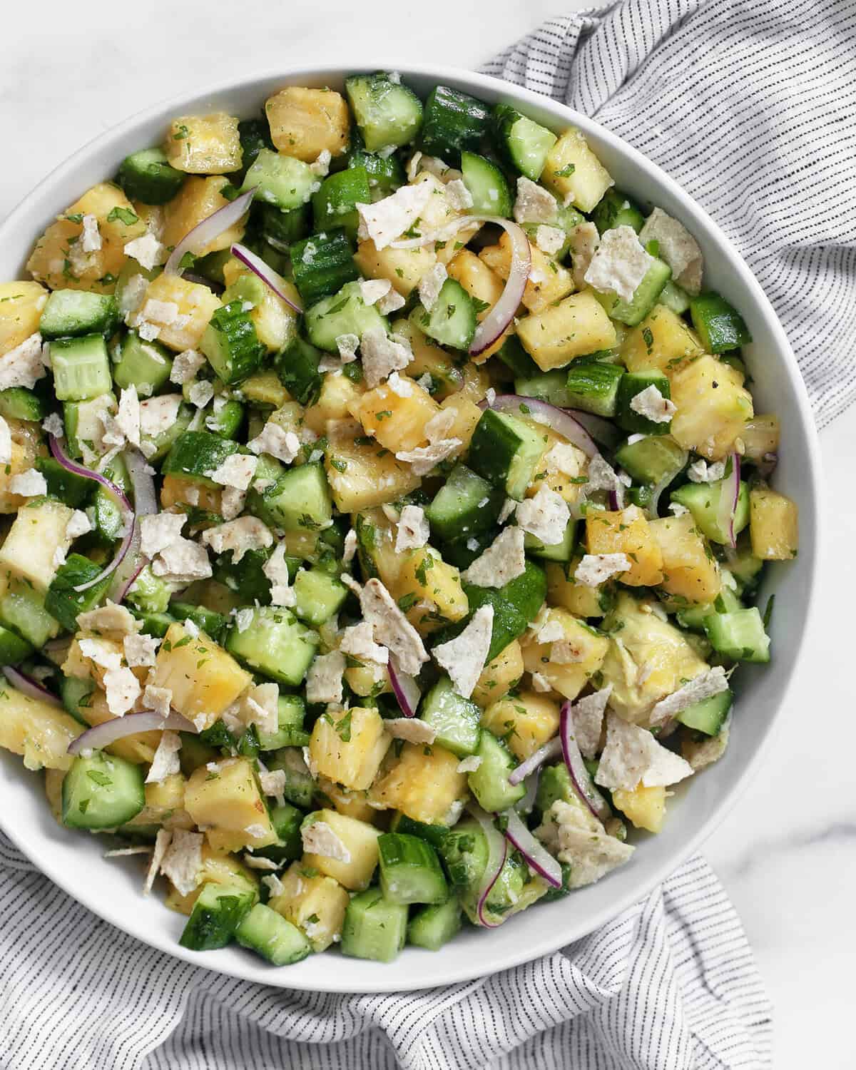 Pineapple cucumber salad in a bowl.