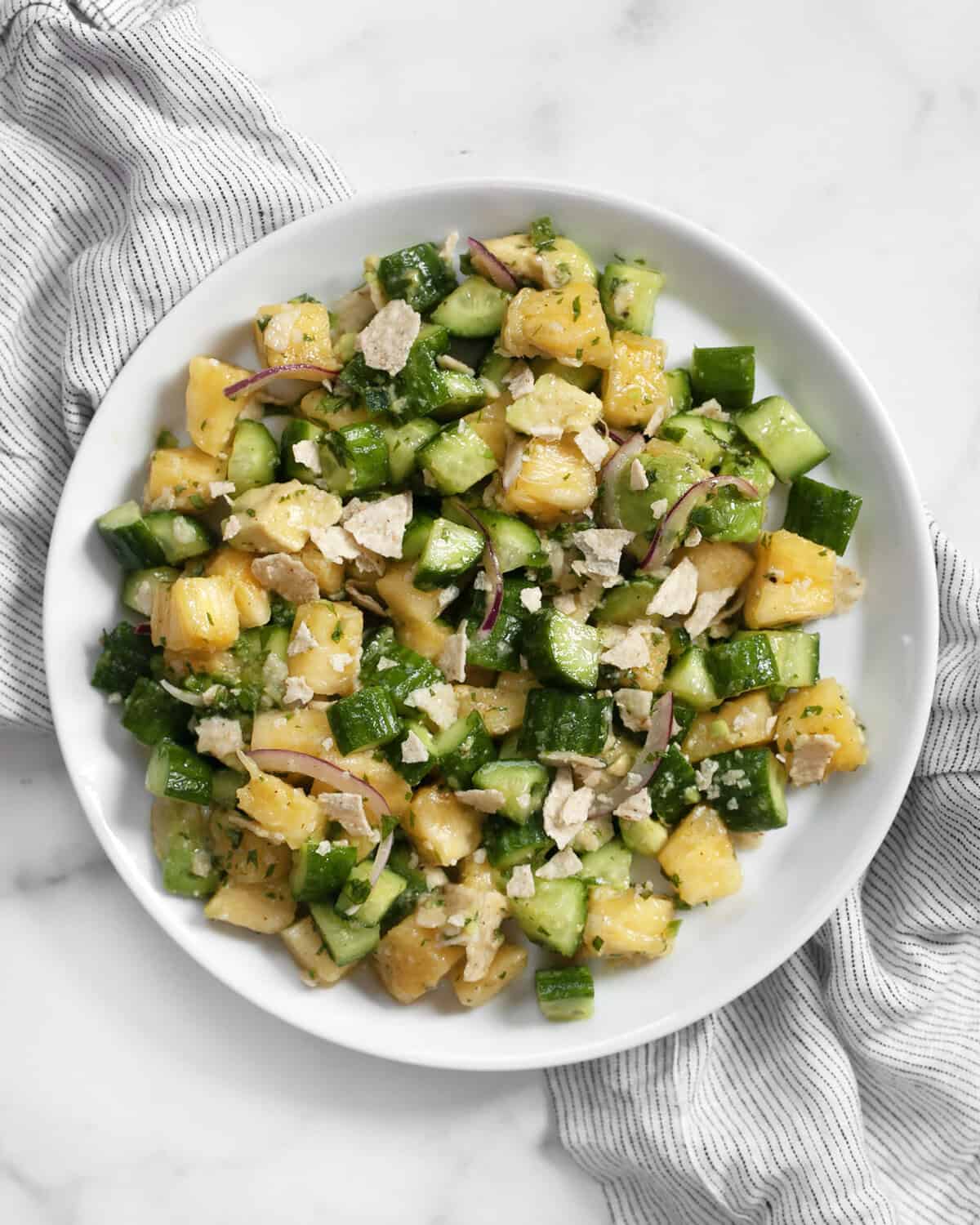 Pineapple cucumber salad on a plate.