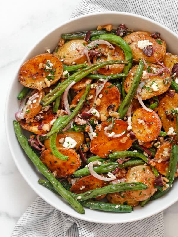 Roasted potato and green bean salad in a bowl.