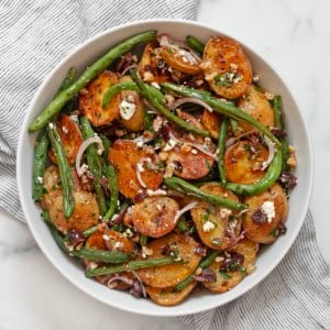 Roasted potato and green bean salad in a bowl.