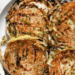 Grilled cabbage steaks on a platter.