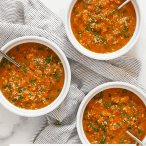 Three bowls of pumpkin soup.