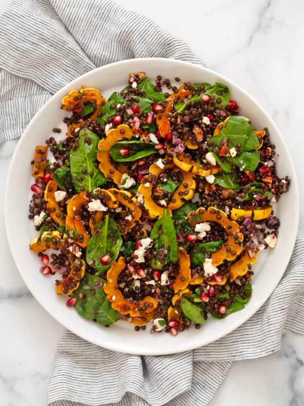 Roasted delicata squash salad on a plate.