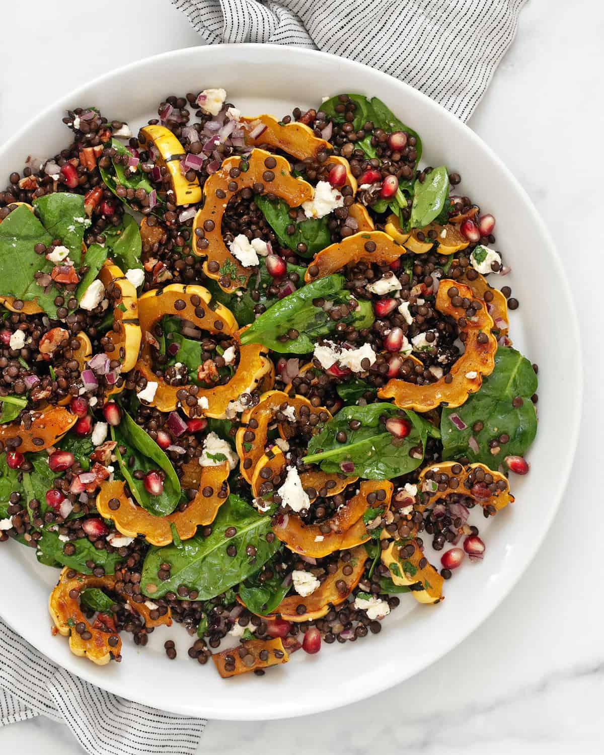 Roasted delicata squash salad on a plate.