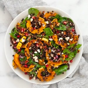 Roasted delicata squash salad on a plate.