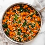 Roasted butternut squash kale orzo in a pan.