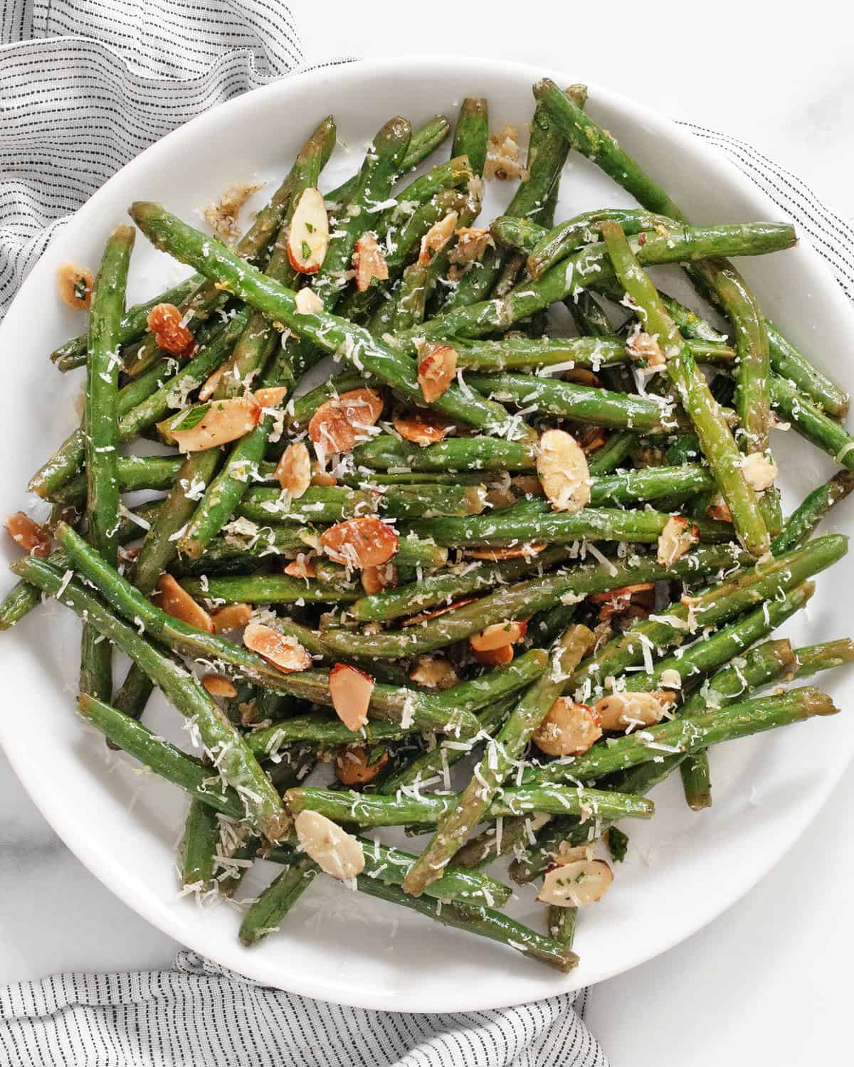 Roasted garlic parmesan green beans on a plate.