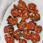 Smashed sweet potatoes on a serving plate.