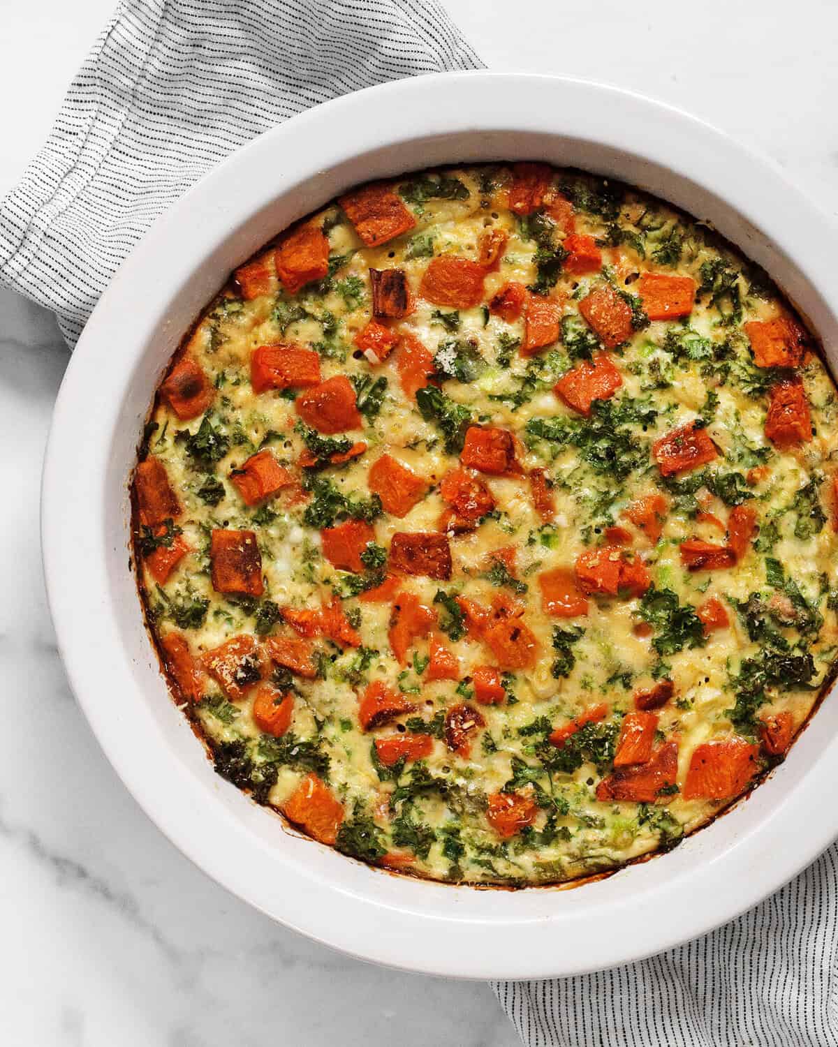 Roasted sweet potato cottage cheese egg bake in a pie dish.