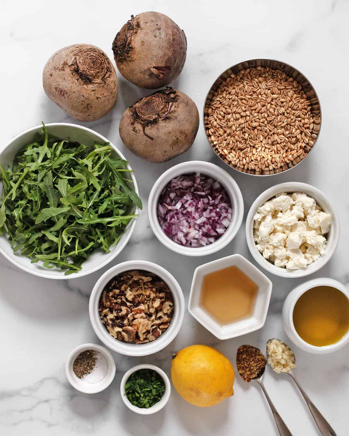 Ingredients including beets, feta, farro, arugula, red onions, walnuts, parsley, salt, pepper, olive oil, garlic and mustard.